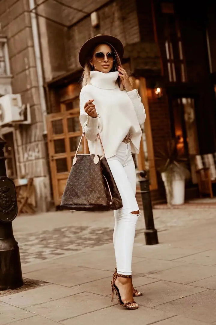 Woman wearing white oversized turtleneck sweater with white jeans