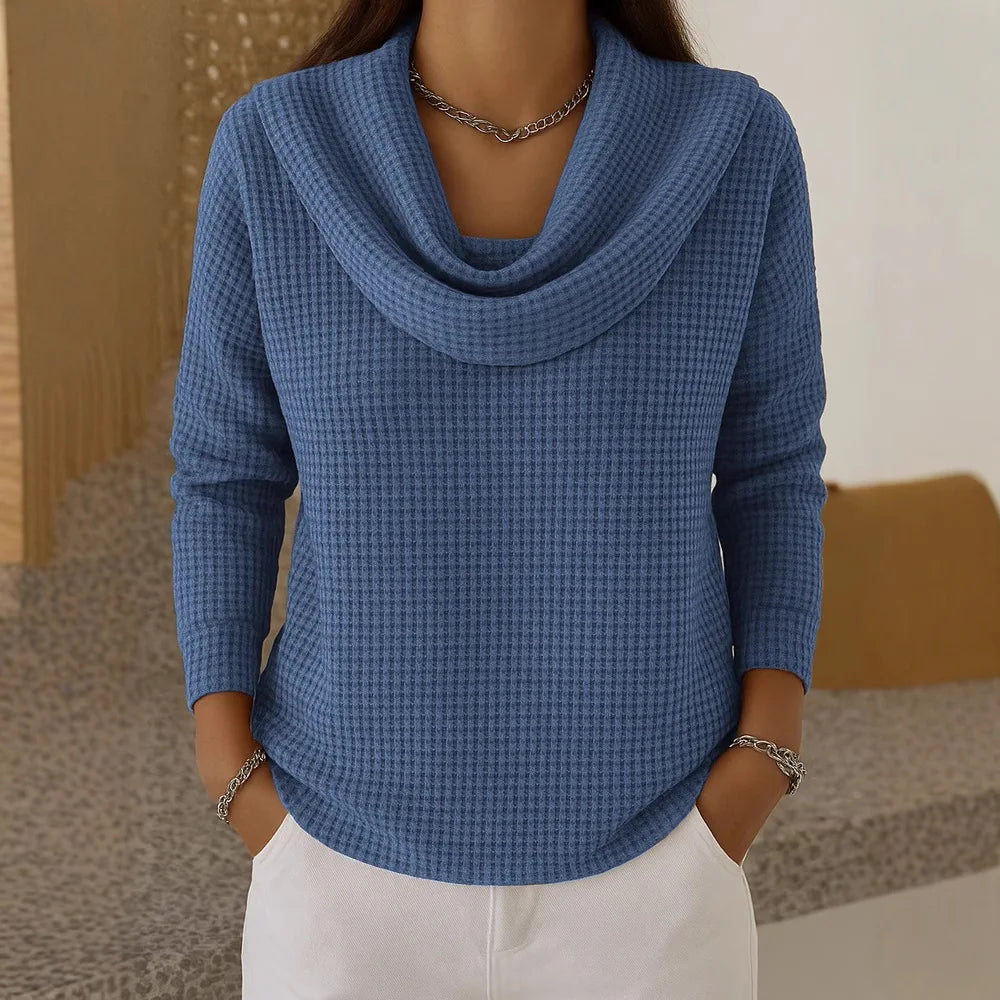 Woman wearing blue waffle knit cowl neck top