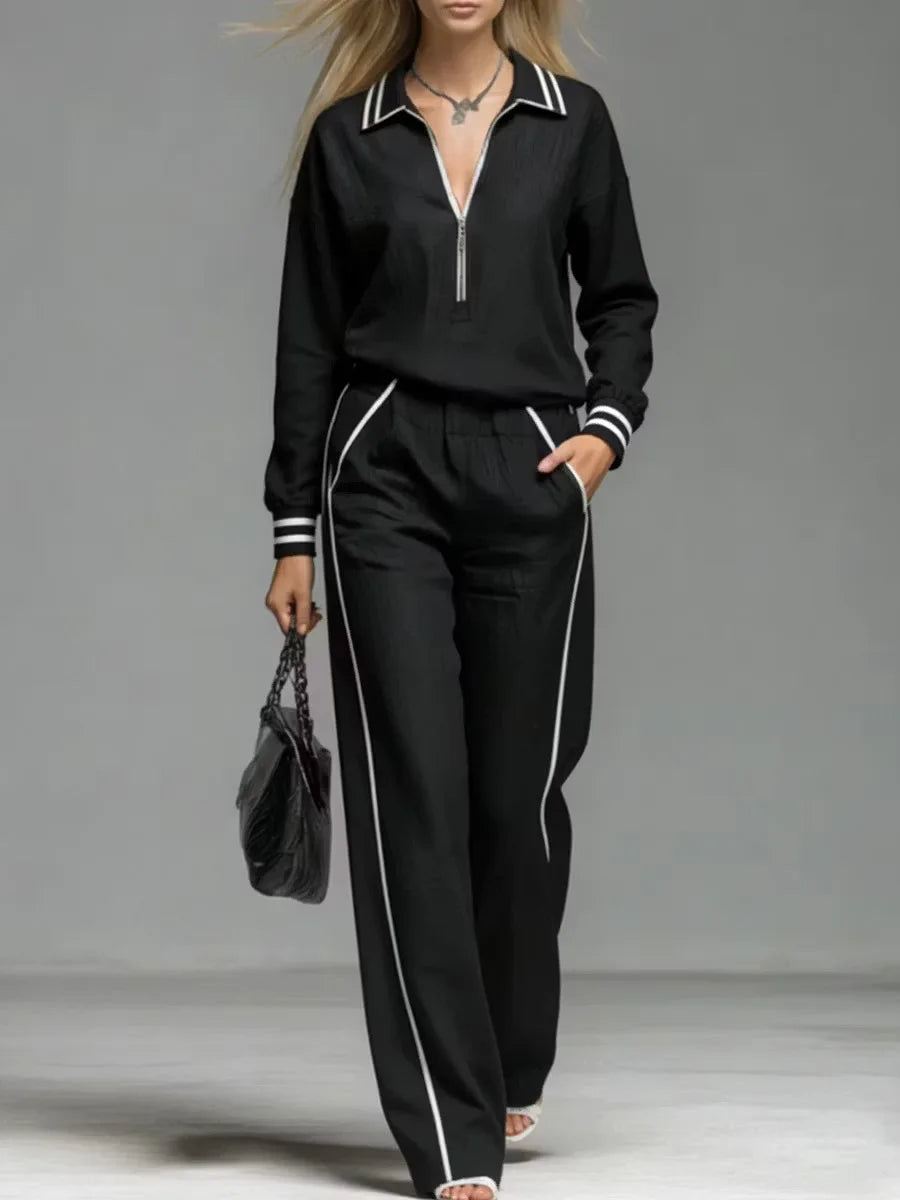 Woman wearing black half-zip two piece pant set close up