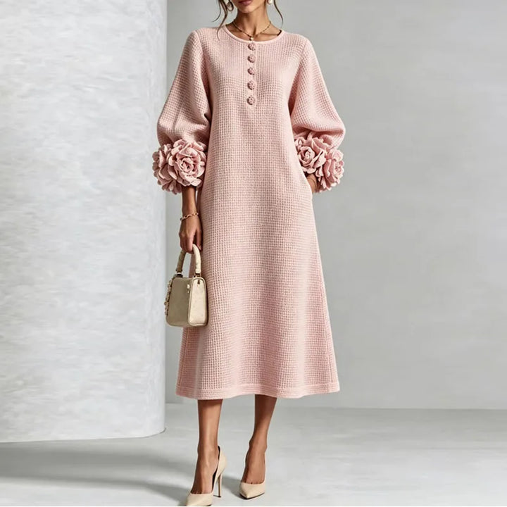 Woman wearing pink knit midi dress with floral cuffs