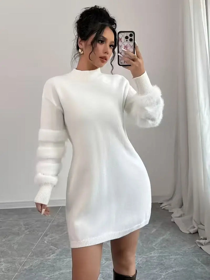 Woman wearing white mock neck sweater dress with fuzzy sleeve detail