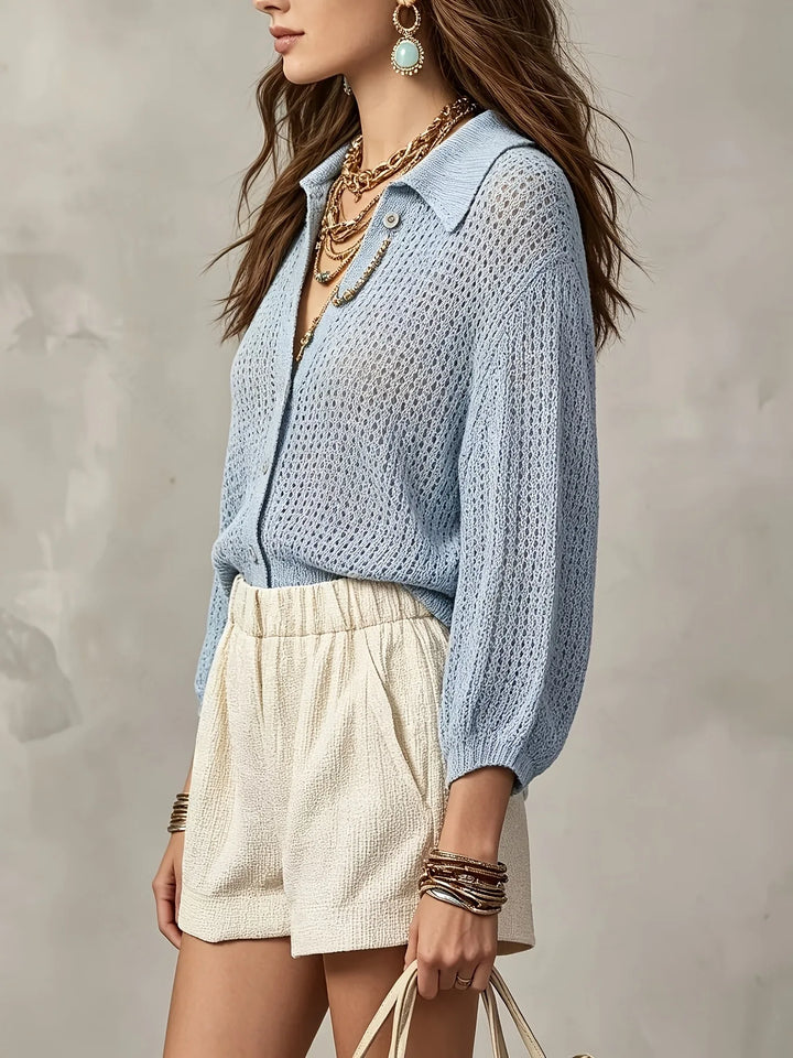 Side view of light blue open crochet knit cardigan with layered necklaces