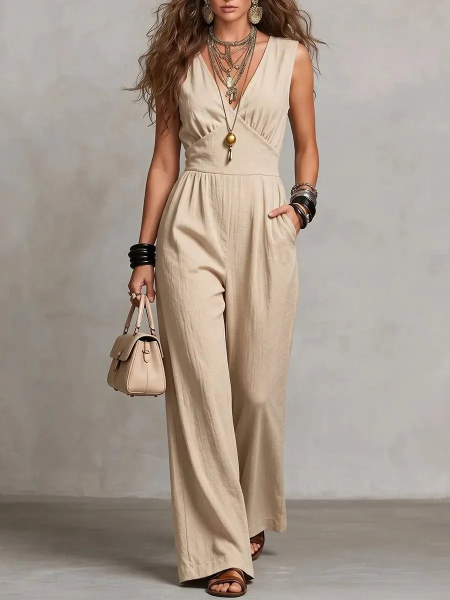 Woman wearing apricot wide leg jumpsuit with empire waist seam