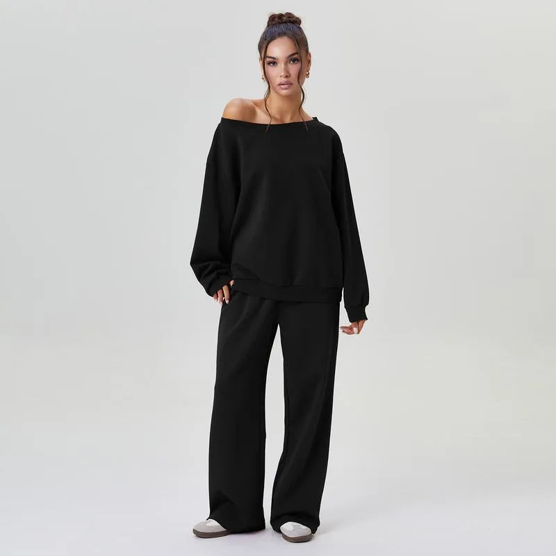 Woman wearing black off-shoulder sweatshirt and wide leg pants front view