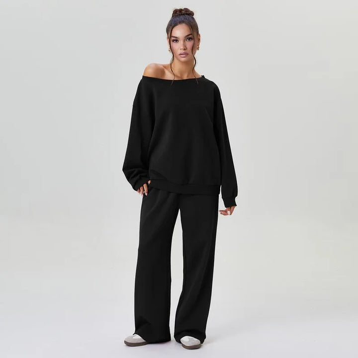 Woman wearing black off-shoulder sweatshirt and wide leg pants front view