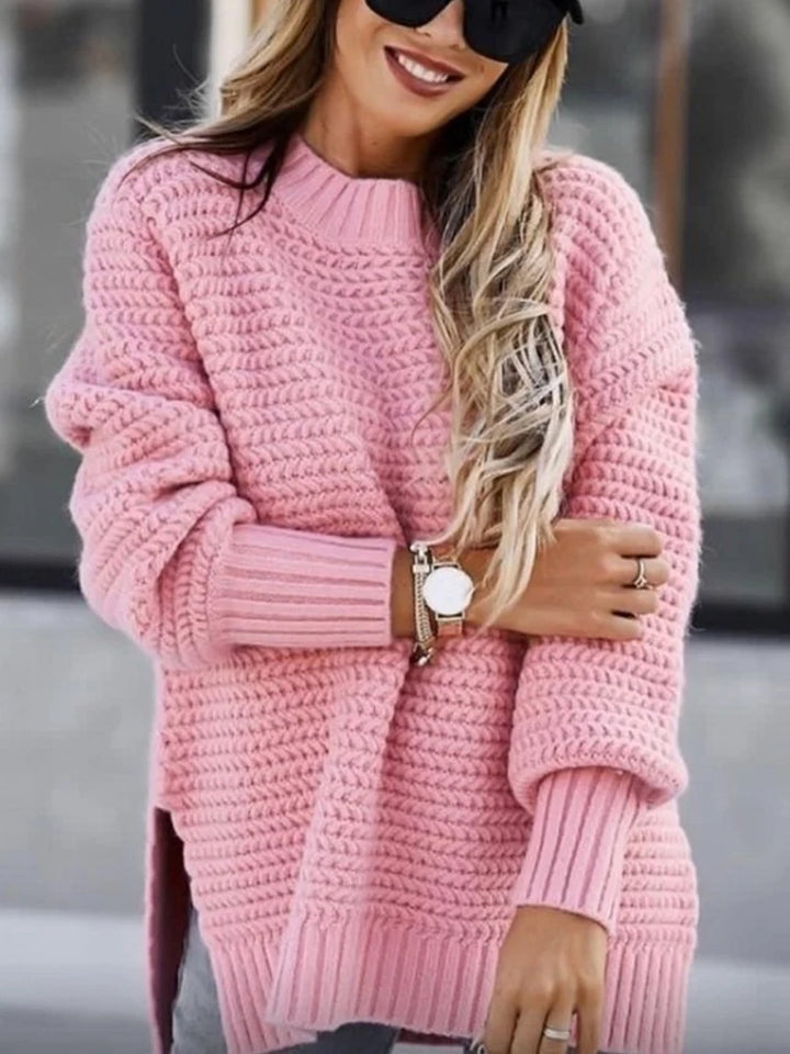Woman wearing pink chunky knit oversized sweater with mock neck