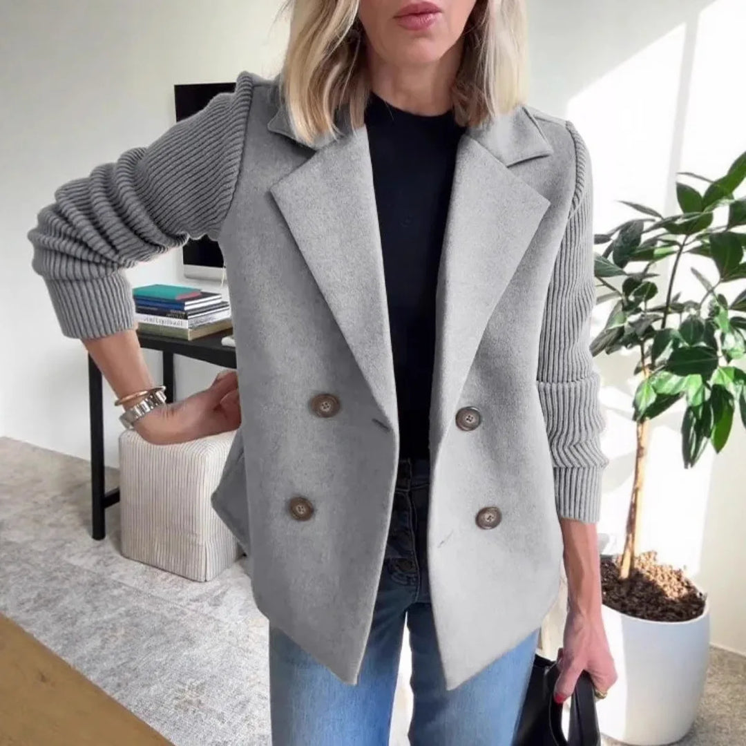 Woman wearing gray double-breasted blazer with ribbed knit sleeves