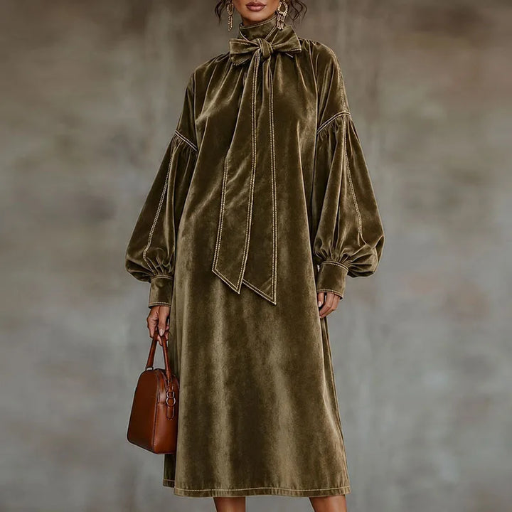 Woman wearing khaki velvet maxi dress with bow tie neckline