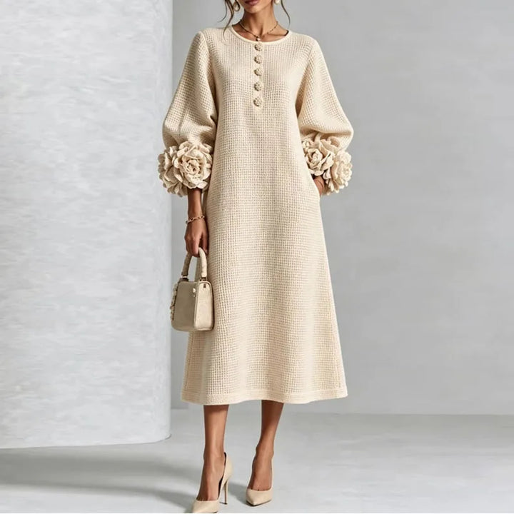 Woman wearing apricot knit midi dress with floral cuffs