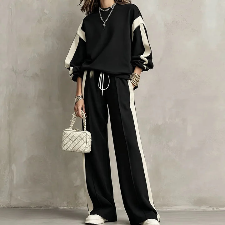 Woman wearing black color block sweatshirt and wide leg pants set, front view