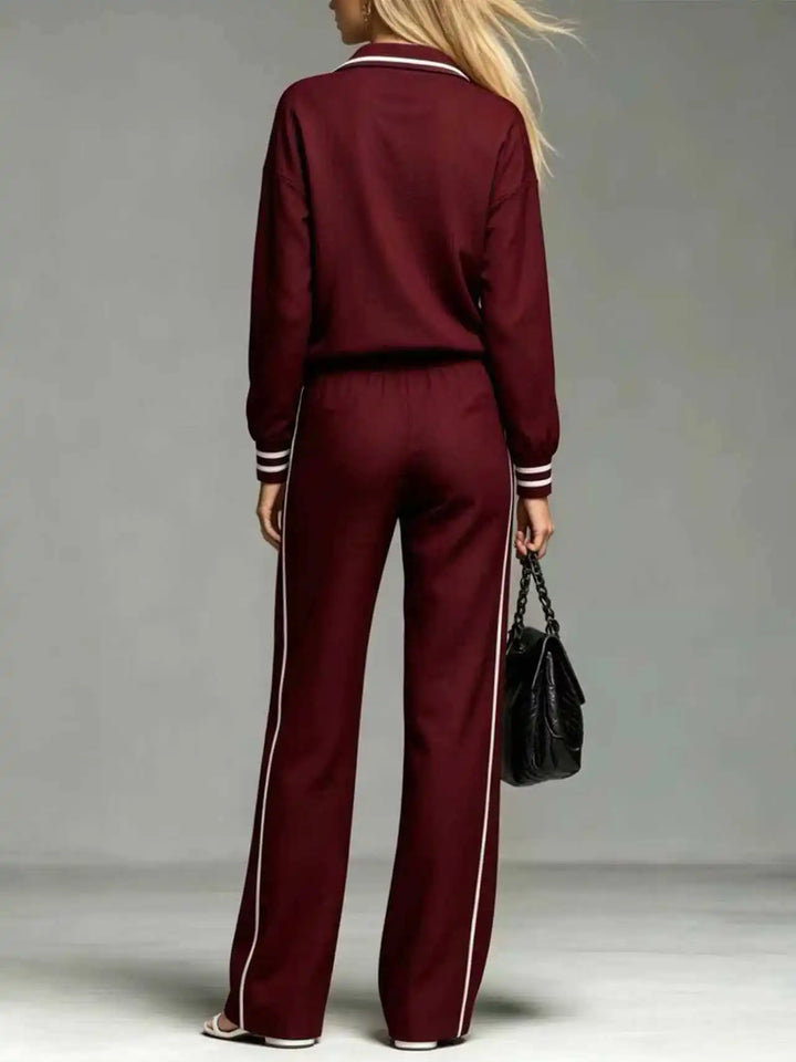 Back view of burgundy half-zip two piece pant set with white piping