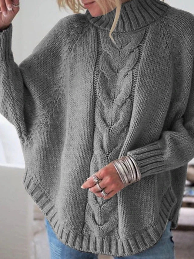 Woman wearing gray cable knit oversized sweater, front view