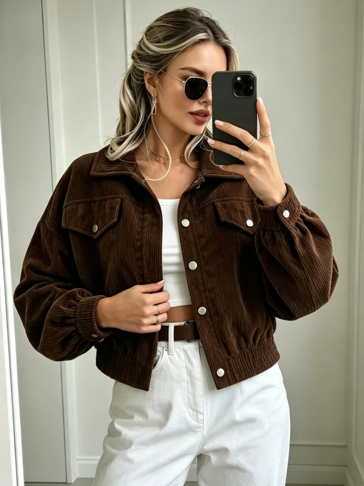 Woman wearing brown corduroy cropped jacket with white jeans