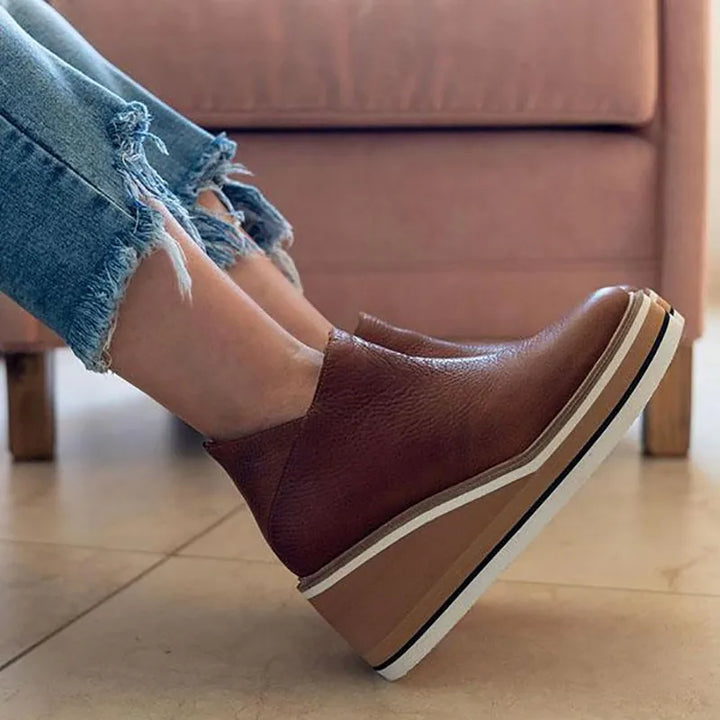 Side view of brown leather platform wedge ankle boot
