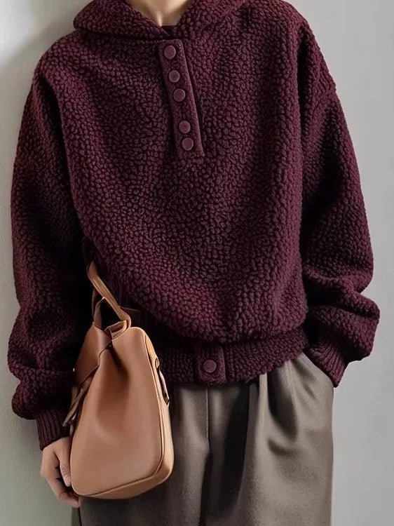 Woman wearing grape purple particle fleece hooded sweatshirt with crossbody bag