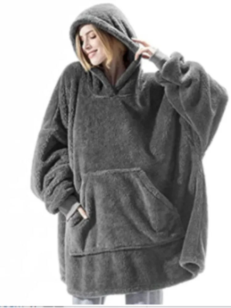 Woman wearing dark grey oversized hooded blanket sweatshirt