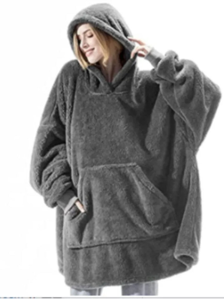 Woman wearing dark grey oversized hooded blanket sweatshirt