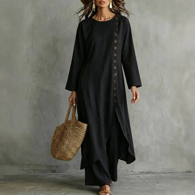 Woman wearing black two piece set with asymmetric button placket top and wide leg pants