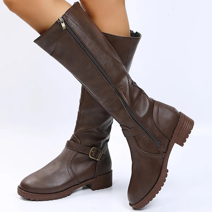 Dark brown knee-high boots with buckle strap, side view