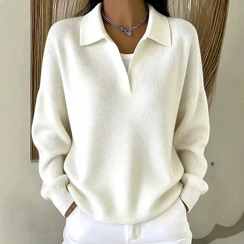 Woman wearing white ribbed knit polo sweater with deep V neckline