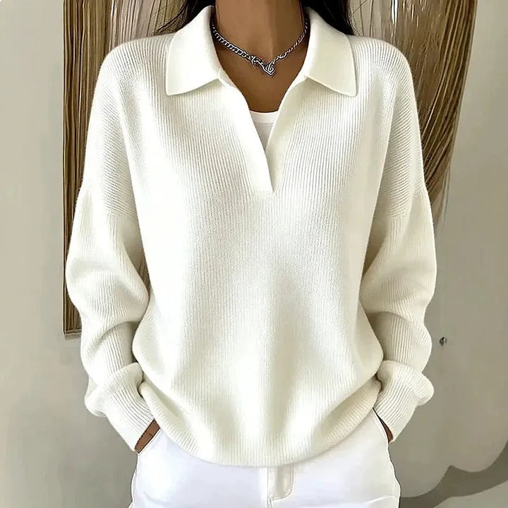 Woman wearing white ribbed knit polo sweater with deep V neckline