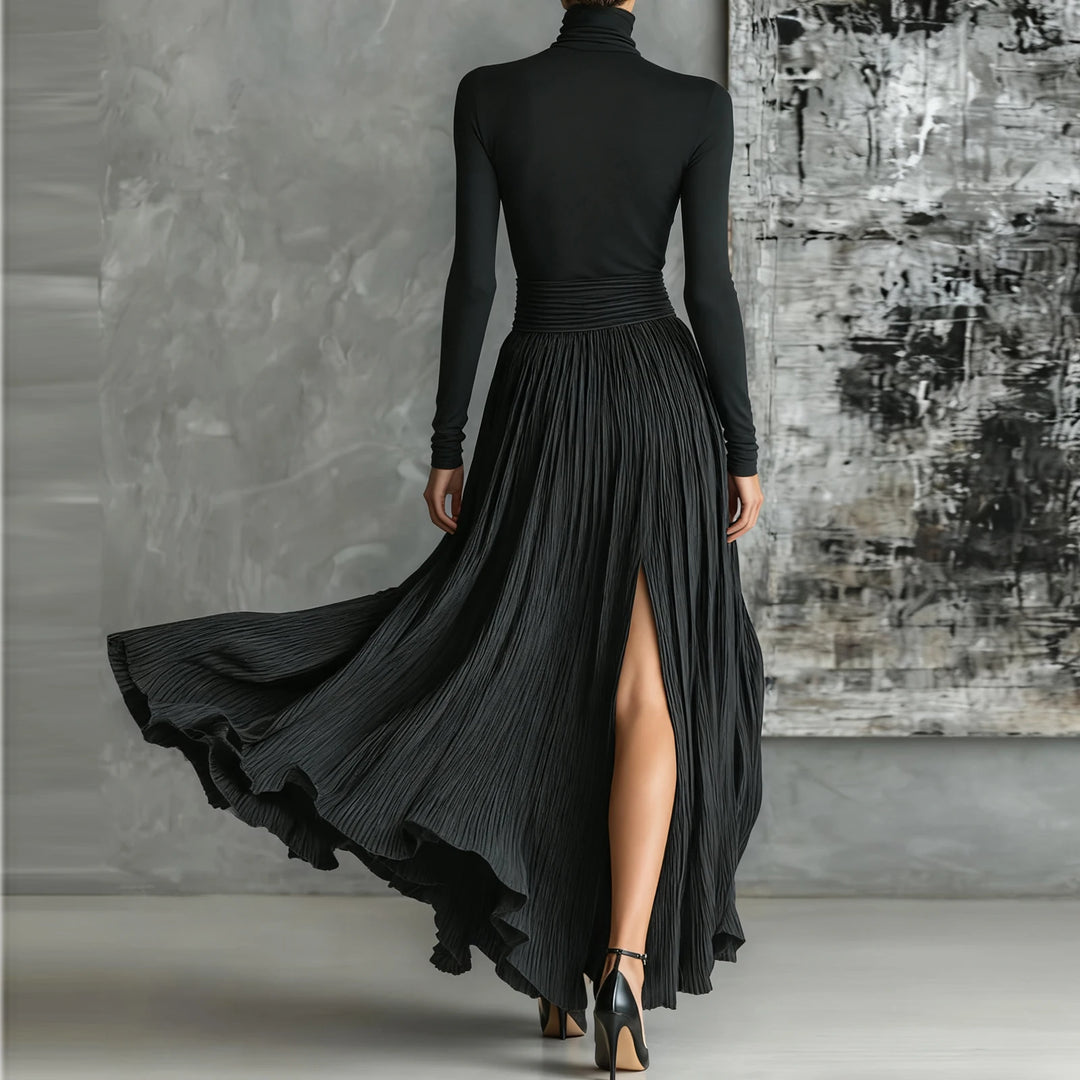 Black turtleneck pleated maxi dress, back view showing side slit