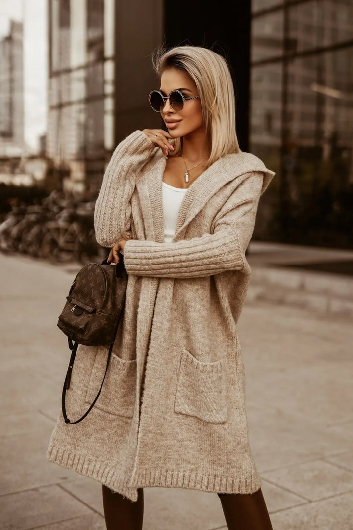 Woman wearing camel hooded longline cardigan with sunglasses