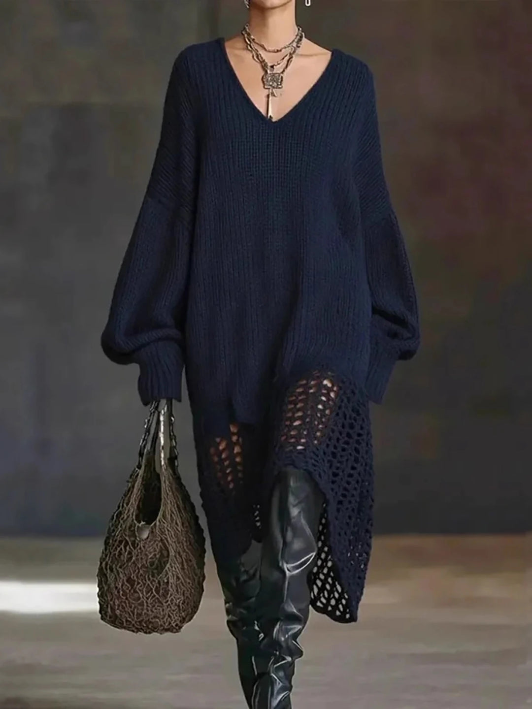 Model in navy blue oversized crochet-hem sweater dress with over-the-knee boots
