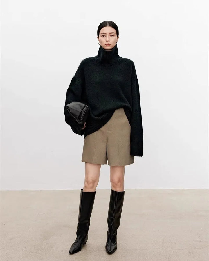 Black turtleneck sweater with khaki shorts and knee-high boots