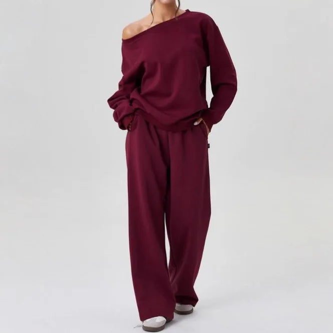 Woman wearing burgundy off-shoulder sweatshirt and wide leg pants