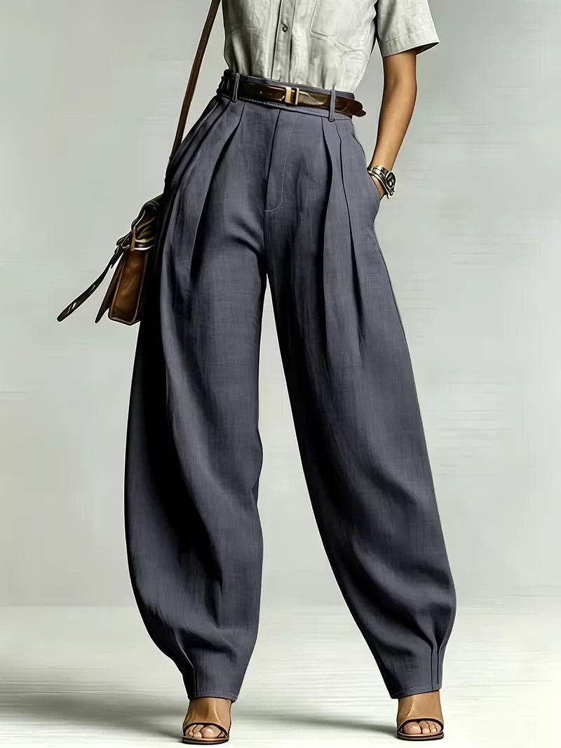 Woman wearing dark gray high-waisted balloon wide leg pants, front view