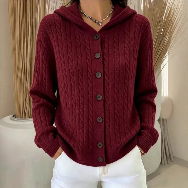 Woman wearing burgundy cable knit hooded cardigan with buttons