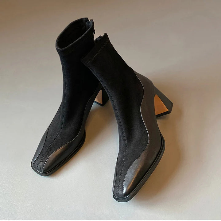 Pair of black ankle boots angled on floor