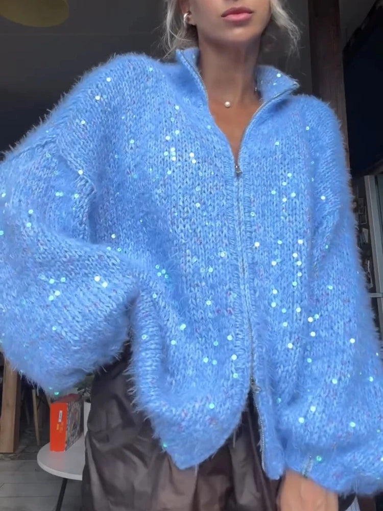Woman wearing blue fuzzy sequin zip cardigan close up