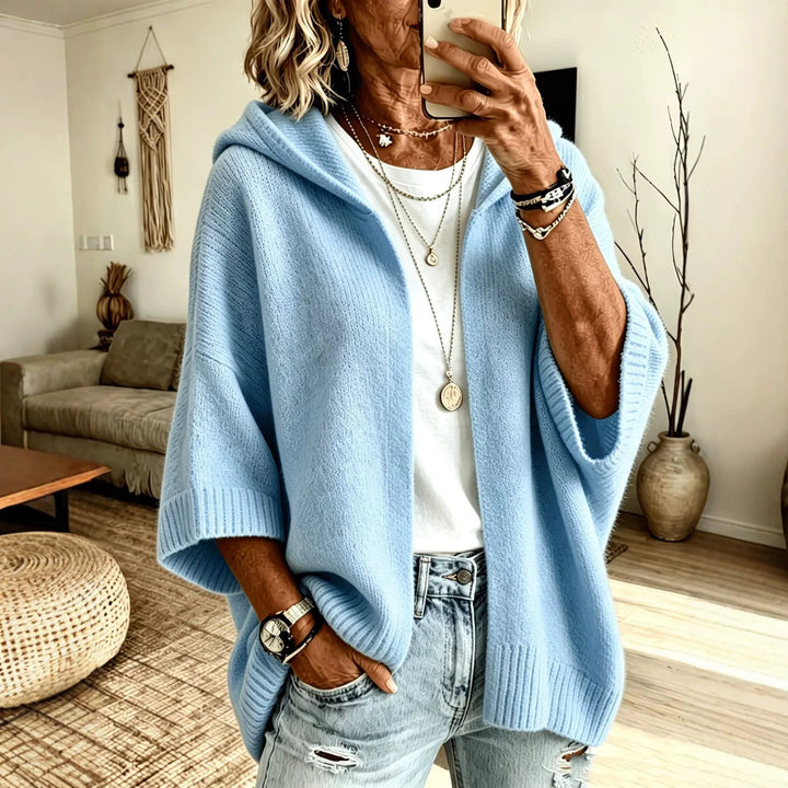 Woman wearing sky blue hooded poncho cardigan with batwing sleeves