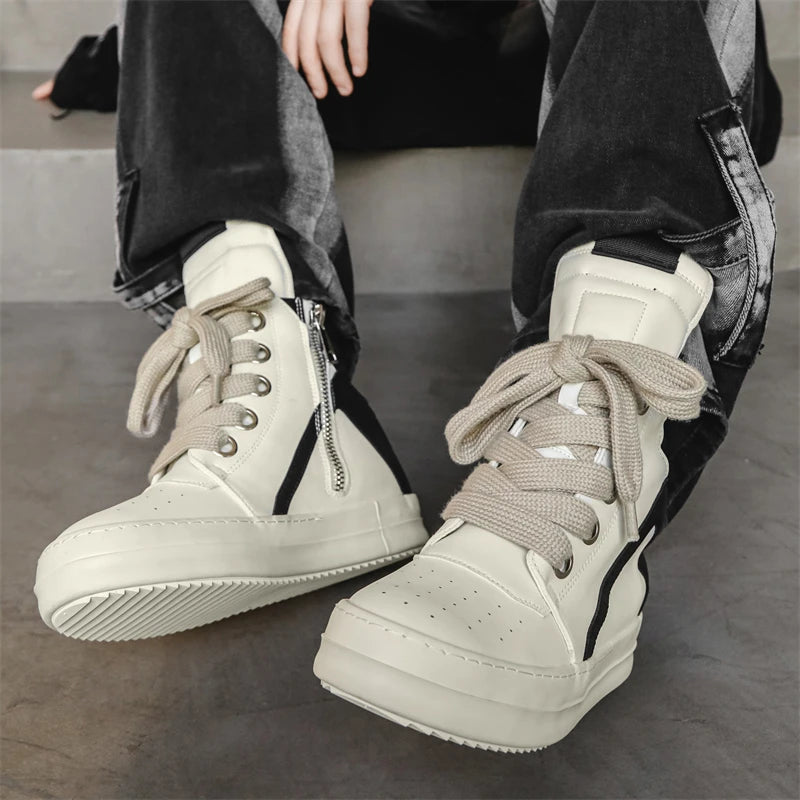 Beige high-top sneakers worn with jeans, side zip and laces