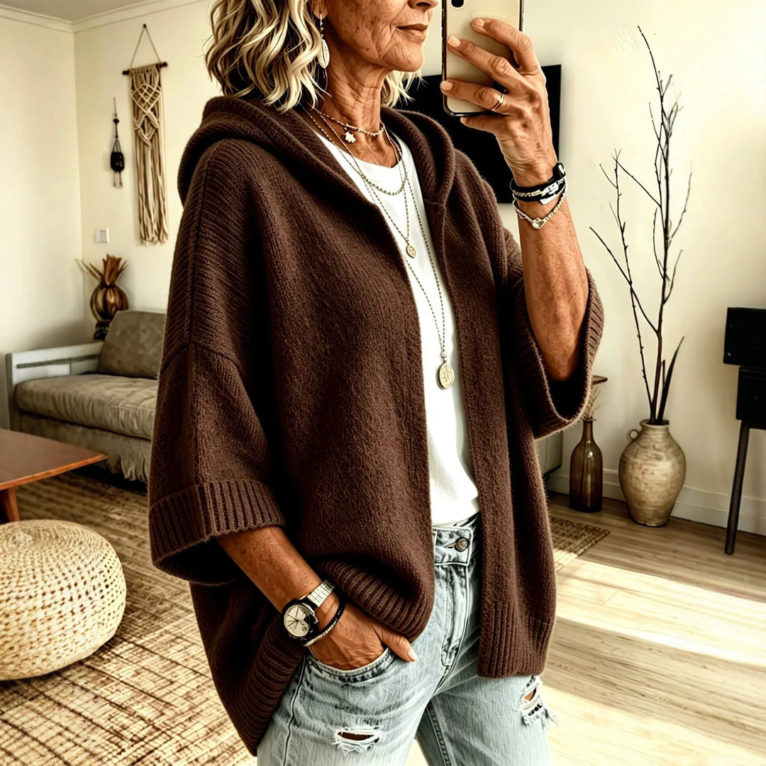 Woman wearing dark brown hooded poncho cardigan with batwing sleeves
