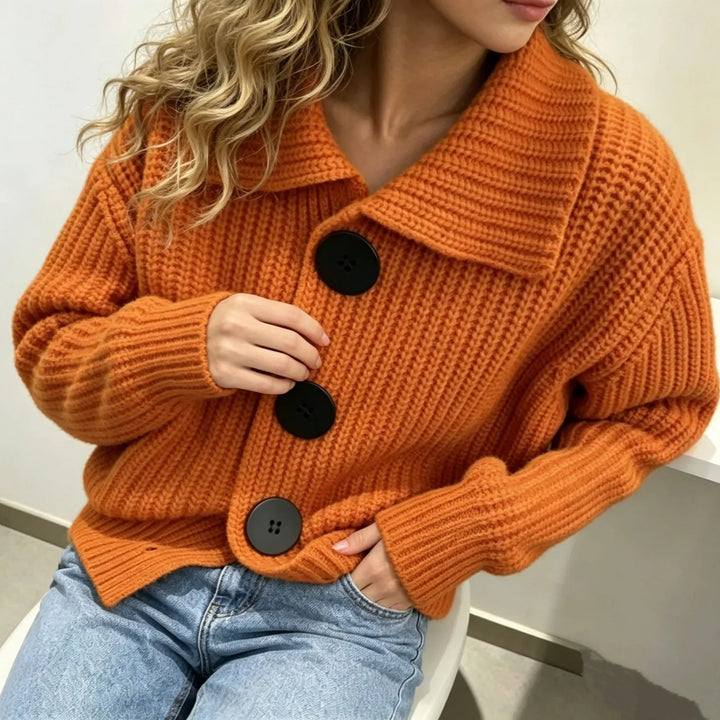 Close up of orange chunky knit cardigan collar and buttons