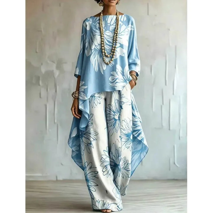 Woman wearing light blue floral two-piece set with asymmetric top and wide leg pants