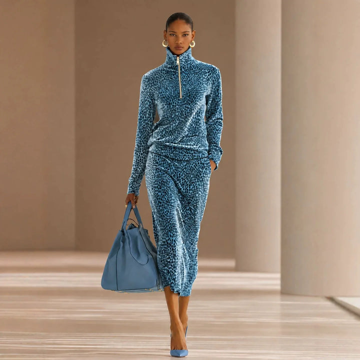 Woman in sky blue leopard print half-zip top and skirt set with handbag