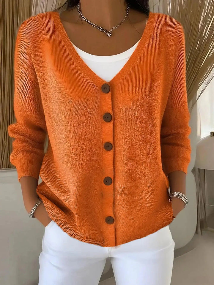 Woman wearing orange button front knit cardigan