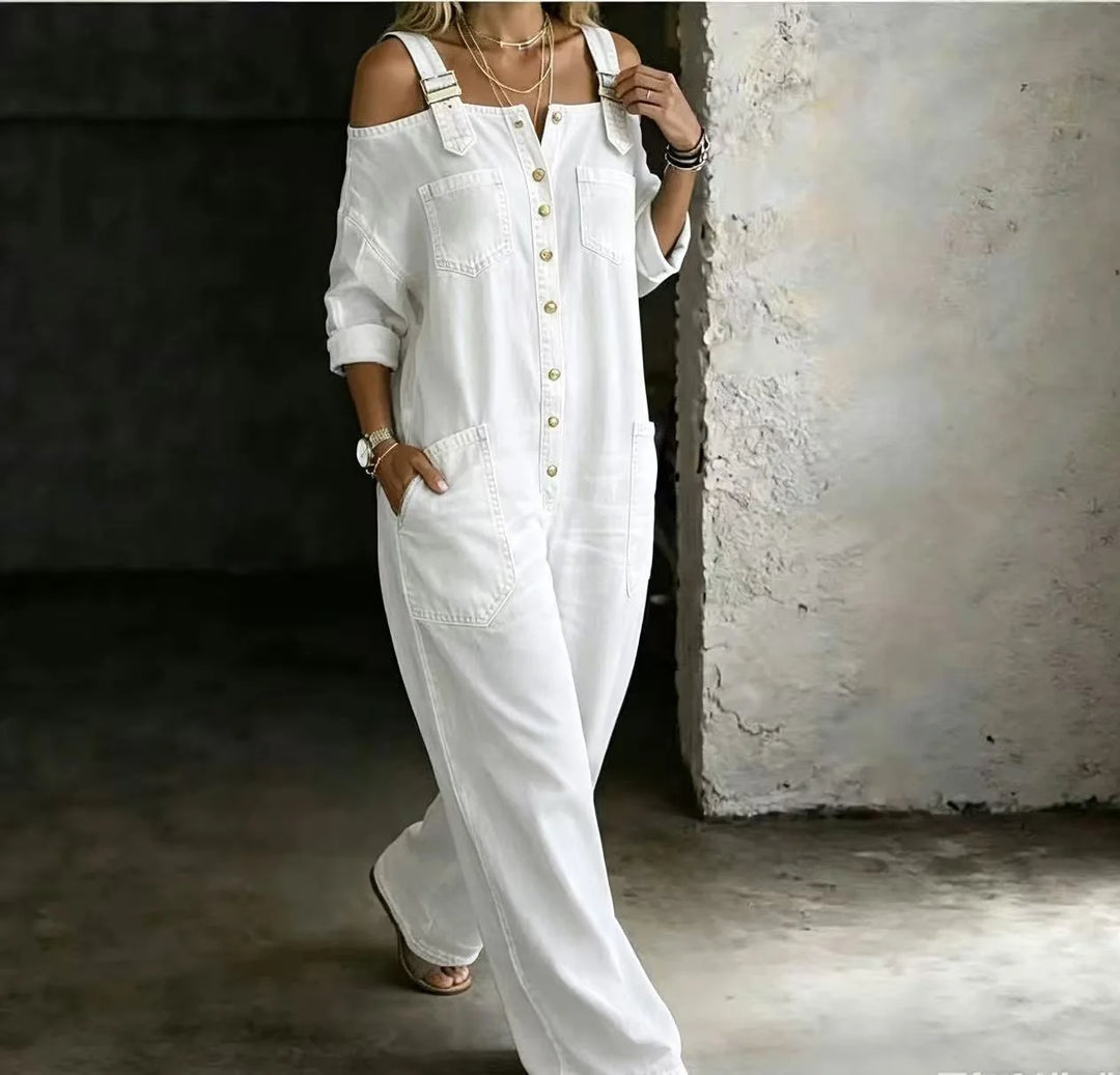 Woman wearing white denim cold shoulder jumpsuit walking