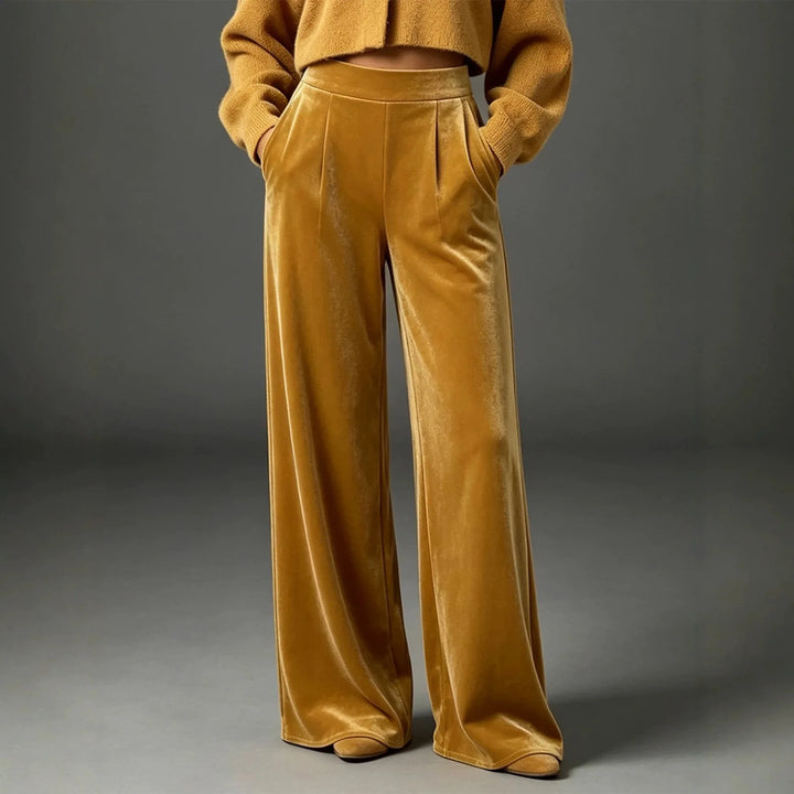 Woman wearing ginger yellow velvet wide leg pants, front view