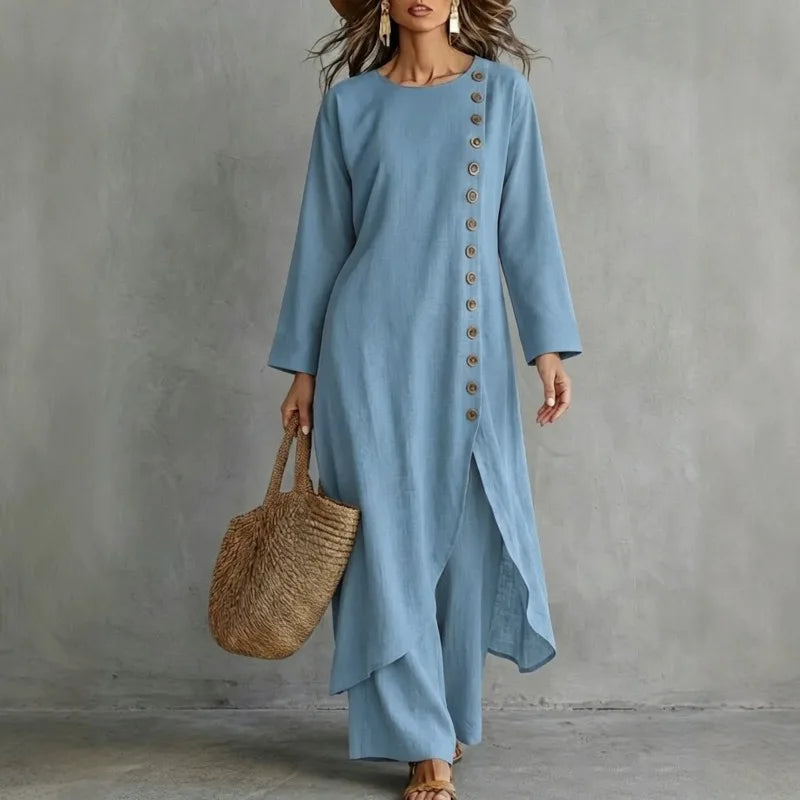 Woman wearing light blue two piece set with asymmetric button placket top and wide leg pants