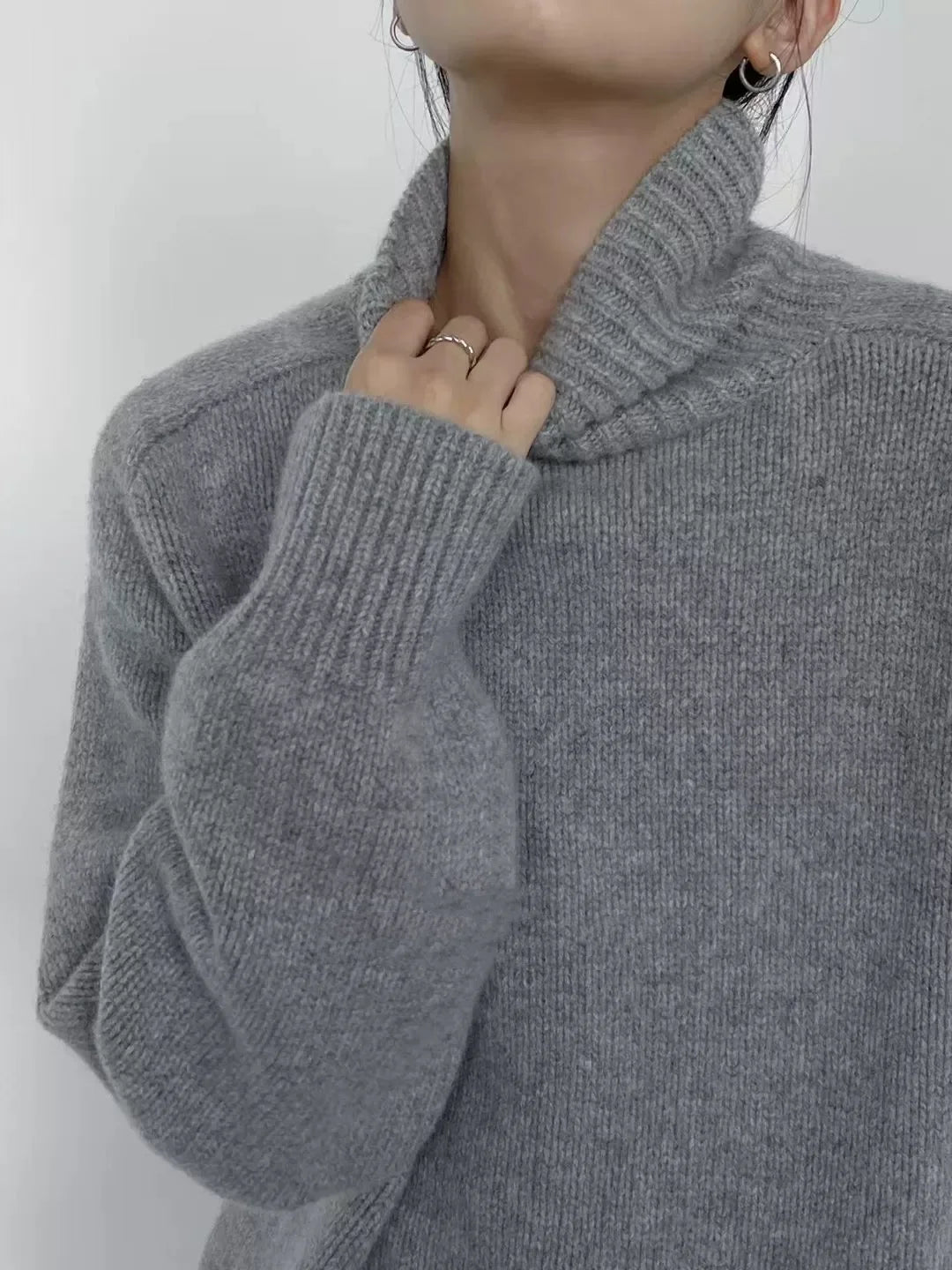 Close up detail of light gray ribbed turtleneck collar