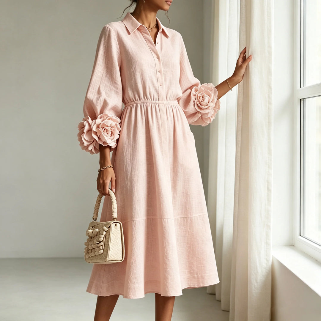 Pink midi dress with floral cuff detail, side angle near window