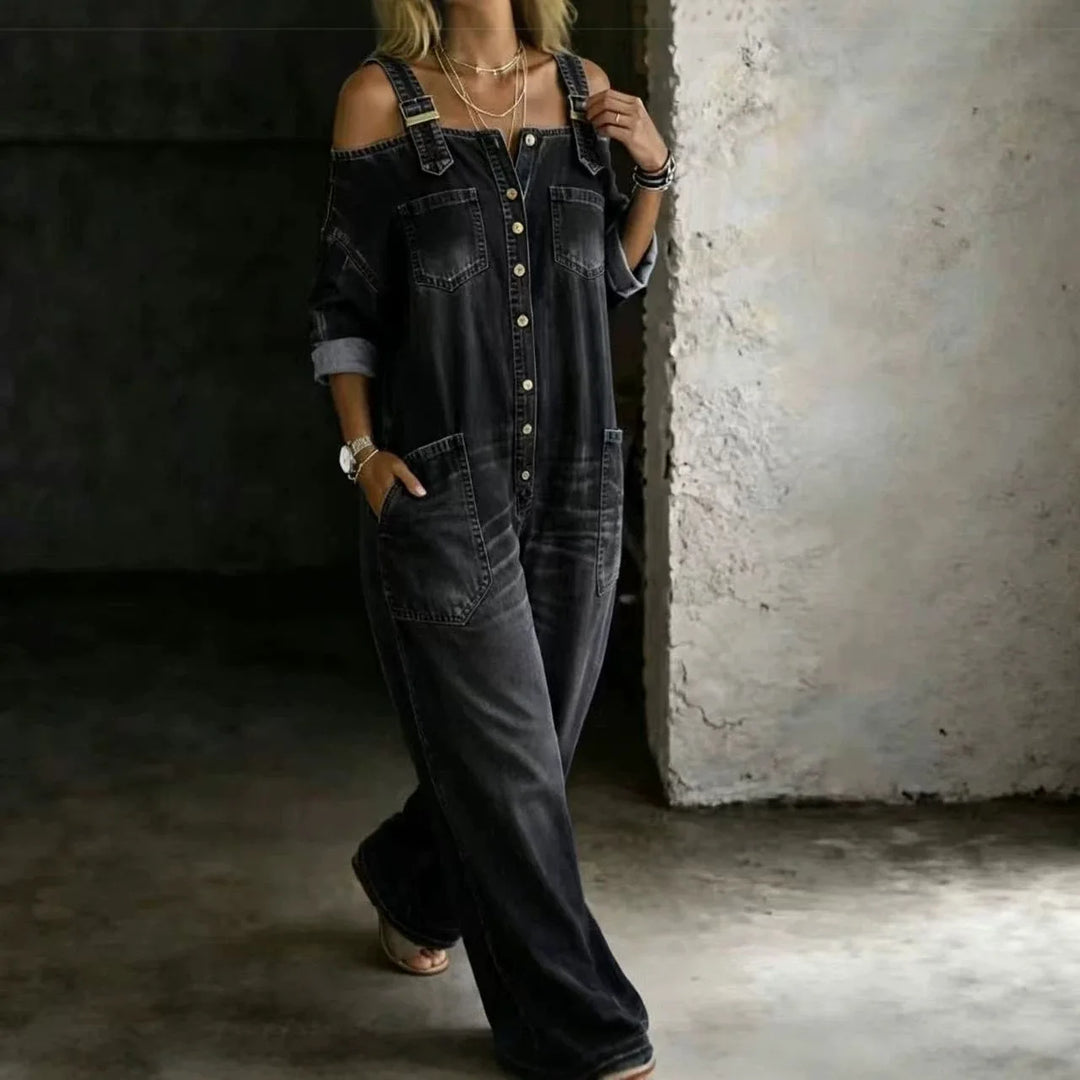 Woman wearing black denim cold shoulder jumpsuit walking