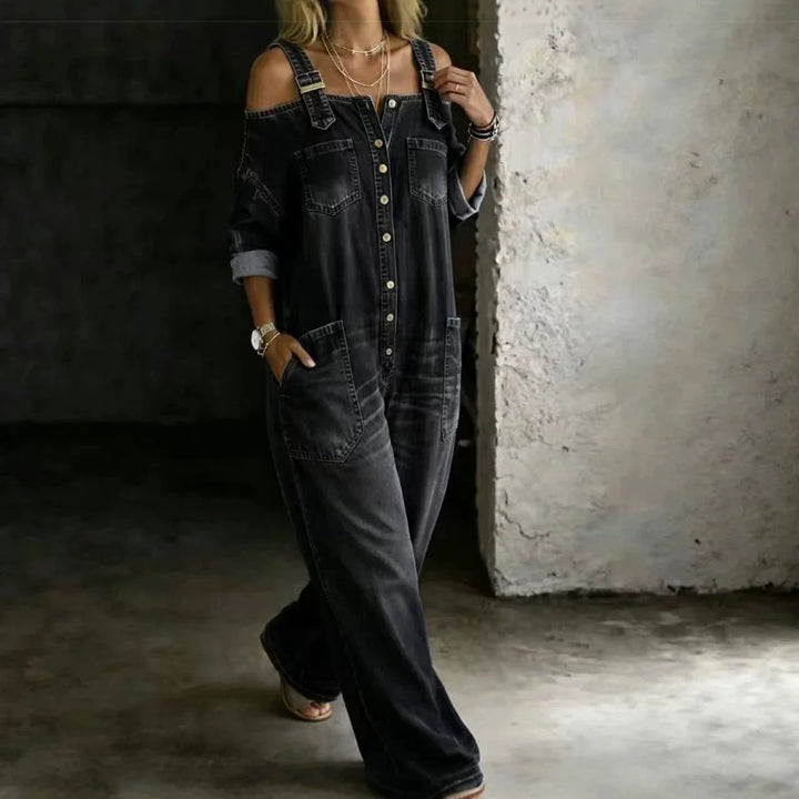 Woman wearing black denim cold shoulder jumpsuit walking