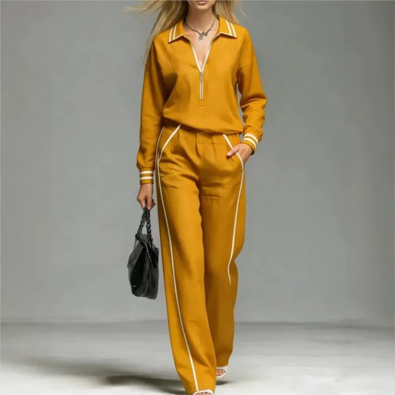 Woman wearing yellow half-zip two piece pant set with contrast stripe trim