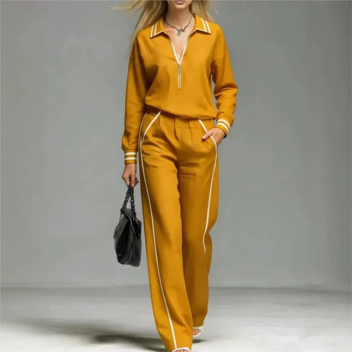 Woman wearing yellow half-zip two piece pant set with contrast stripe trim